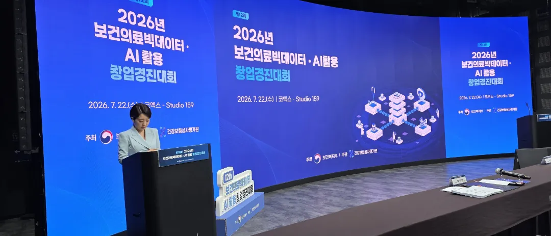 공식 톤의 아나운서 진행과 3면 LED 화면